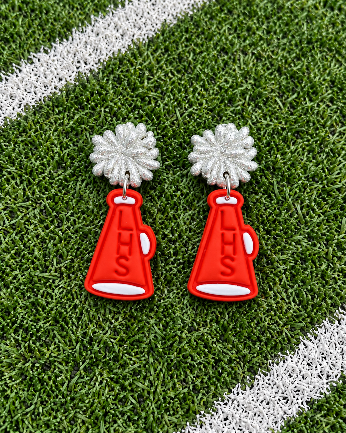 Red and white LHS megaphone dangle earrings with sparkling silver pom-pom stud tops, cute cheerleading and school spirit jewelry for football games and pep rallies.
