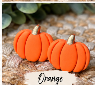 Colorful pumpkin stud earrings in orange, pink, green, blue, white, black, leopard print, and other fall colors displayed together.